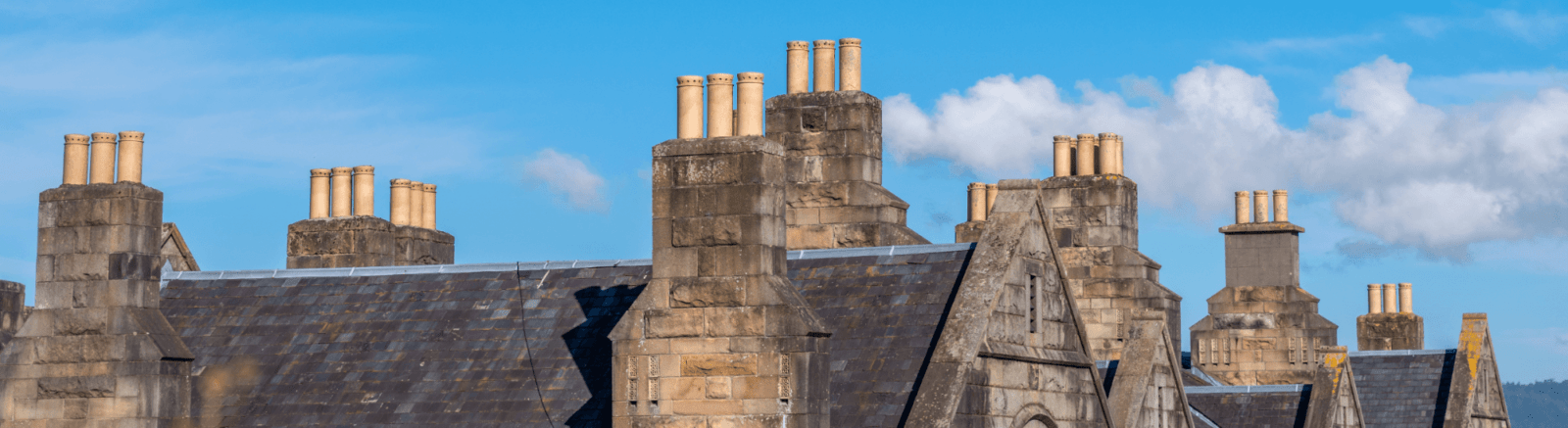 blue background with chimneys on roof